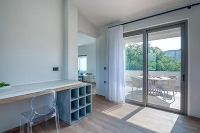 a kitchen with a counter and a table with chairs at Alyona Villas - Villa Lona in Skinés