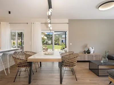 a dining room and living room with a table and chairs at HappyHouse Villa in Kissamos