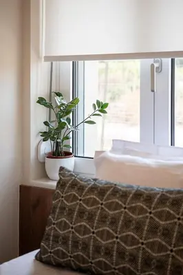a bedroom with a bed and a window with a plant at HappyHouse Villa in Kissamos