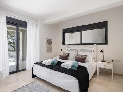 a bedroom with a large white bed with a large window at Mediterranean villa Seaview privet pool in Tersanas