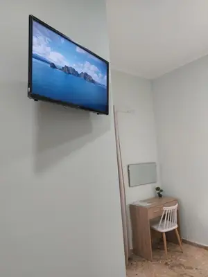 a flat screen tv hanging on a wall at Maria's sala in Kissamos