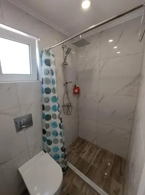 a bathroom with a shower and a toilet at Maria's sala in Kissamos