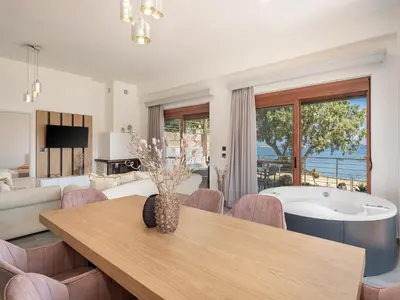 a living room with a table and a bath tub at Elia Seaside Deluxe Apartment in Chania Town