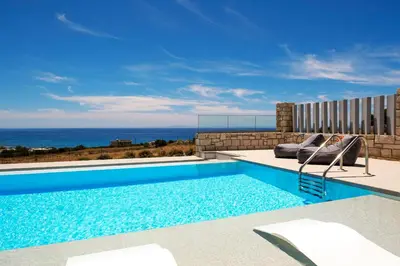 a swimming pool with a view of the ocean at FYSIOPHYLIA VILLAS in Frangokastello