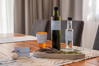 a table with two bottles of wine and a glass at FYSIOPHYLIA VILLAS in Frangokastello