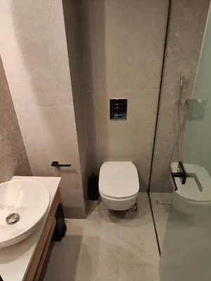 a bathroom with a toilet and a sink at Ammos Paleochora Hotel in Palaiochóra