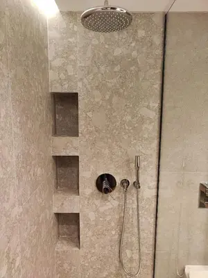 a shower with a shower head in a bathroom at Ammos Paleochora Hotel in Palaiochóra