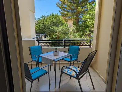 a patio with a table and chairs on a balcony at ALMA central apartment in Chania Town