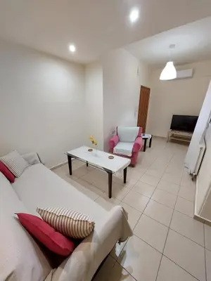 a living room with a couch and a table at ALMA central apartment in Chania Town