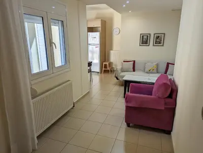 a living room with a purple chair and a table at ALMA central apartment in Chania Town