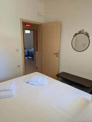 a bedroom with a bed with two towels on it at ALMA central apartment in Chania Town