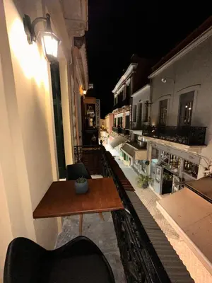 a table and chairs on a balcony at night at Domus Bettolo in Chania Town