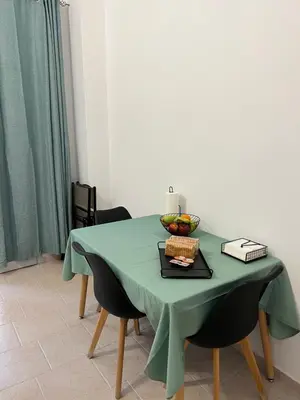 a table with a green table cloth and fruit on it at Domus Bettolo in Chania Town