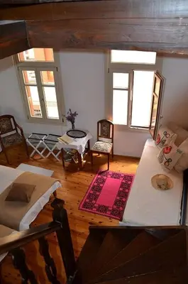 a living room with two beds and a table at Myron House in Chania Town