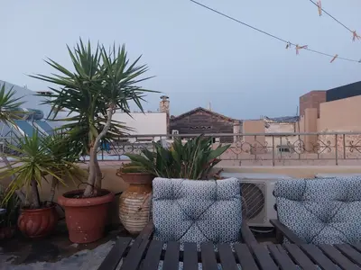 a balcony with a bench and potted plants at Myron House in Chania Town