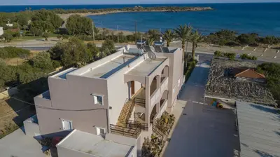 an aerial view of a house with the ocean in the background at Morpheas Rooms in Palaiochóra