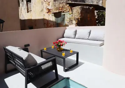 a patio with a couch and a coffee table at Porto 57 in Chania Town