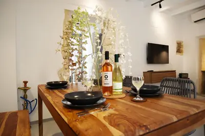 a wooden table with a bottle of wine and glasses at Porto 57 in Chania Town