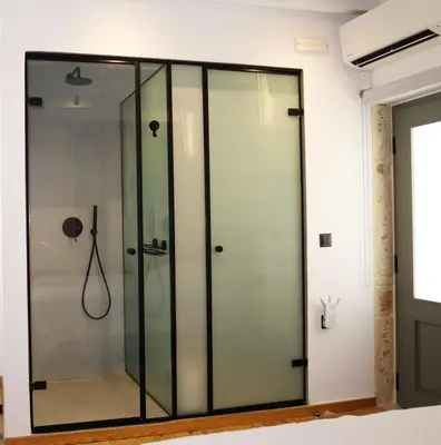 a shower with glass doors in a room at Porto 57 in Chania Town