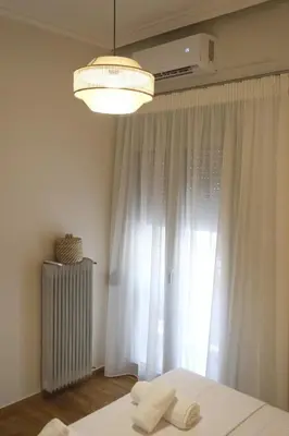 a bedroom with a bed and a window at ZEN central flat with seaview by 8essentially in Chania Town