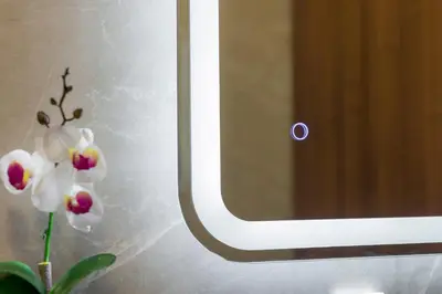 a picture of a white orchid next to a mirror at Anna Boutique Apartment in Kato Daratso