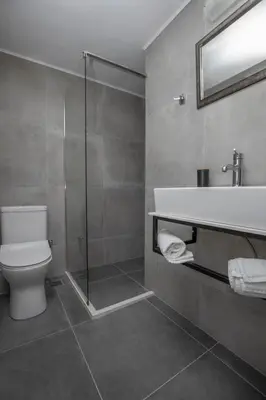 a bathroom with a toilet and a sink and a shower at El Greco Studios in Agia Marina Nea Kydonias