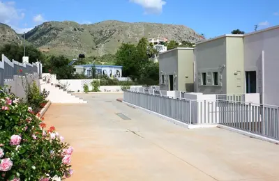 a group of buildings with mountains in the background at Aptera Paradise With Sea View in Megála Khoráfia