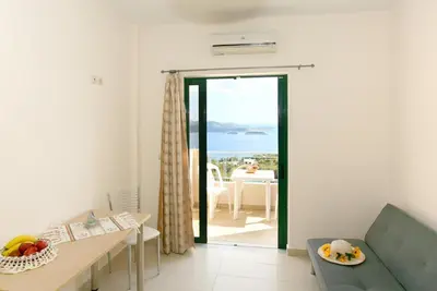 a living room with a view of the ocean at Aptera Paradise With Sea View in Megála Khoráfia