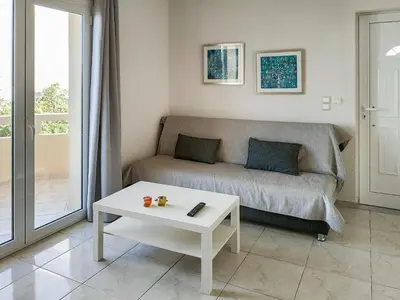 a living room with a couch and a coffee table at Pasithea apts in Almirida