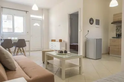 a living room with a couch and a table at Pasithea apts in Almirida