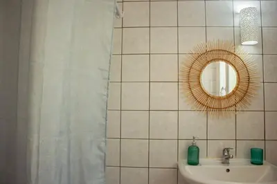a bathroom with a sink and a mirror at Amygdalia Traditional House in Chania Town