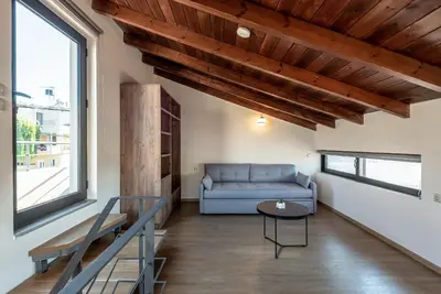 a living room with a couch and a table at Aelia by PosarelliVillas in Kounoupidhianá