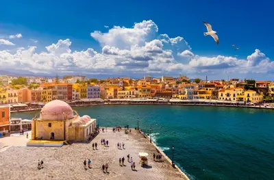 a group of people walking on a pier next to the water at Erofili central apartment in Chania Town