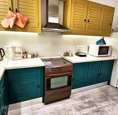 a kitchen with green cabinets and a stove top oven at Erofili central apartment in Chania Town