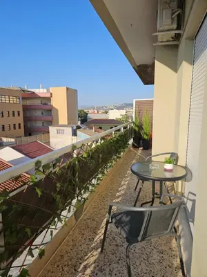 a patio with a table and chairs on a balcony at Erofili central apartment in Chania Town