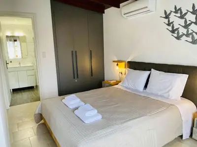 a bedroom with a bed with two towels on it at Charming house 8 minutes walk from Almyrida beach in Almirida