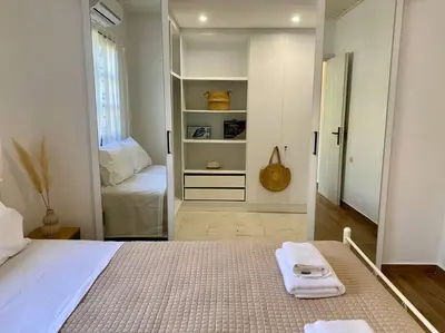 a bedroom with a bed with two towels on it at Charming house 8 minutes walk from Almyrida beach in Almirida