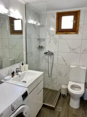 a bathroom with a toilet and a sink and a shower at Charming house 8 minutes walk from Almyrida beach in Almirida