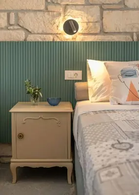 a bedroom with a bed and a nightstand next to a bed sidx sidx sidx at Gramvousa's Hidden Gem in Áyios Yeóryios