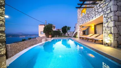 a swimming pool in front of a house at Villa Majestic Crete heated pool and sauna in Megála Khoráfia