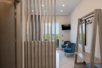 a living room with a sliding door with a table and chairs at Alexia Seaview Apartments in Kissamos