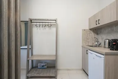 a kitchen with a door leading into a kitchen with a counter at Alexia Seaview Apartments in Kissamos