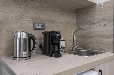 a coffee maker sitting on a counter next to a sink at Alexia Seaview Apartments in Kissamos