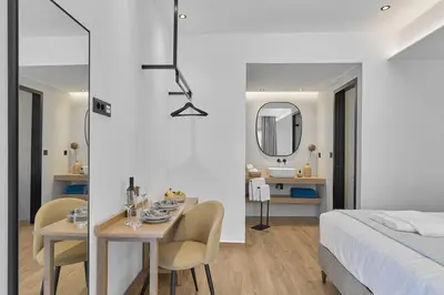 a bedroom with a bed and a table and chairs at Orfeas Apartment in Chania Town