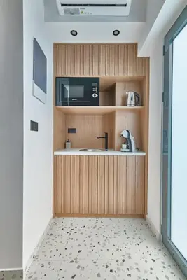 a kitchen with a sink and a microwave at Orfeas Apartment in Chania Town