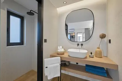 a bathroom with a sink and a mirror at Orfeas Apartment in Chania Town