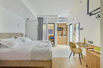 a bedroom with a bed and a desk and a chair at Orfeas Apartment in Chania Town