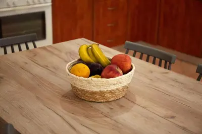 a basket of fruit sitting on a wooden table at Sylvias Stylish Apartment in Chania Town
