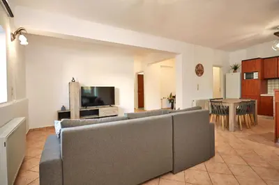a living room with a couch and a tv at Sylvias Stylish Apartment in Chania Town