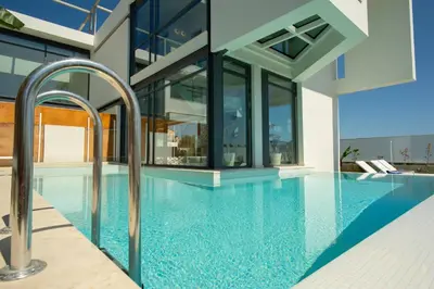 a swimming pool in a house with glass walls at Luxury Villa Glass - 200 meters From The Beach no6 in Daratso